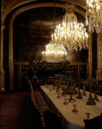 Saint O'Niell Alchemy Manor Born luxury scented candle is evocative of this dark, gilded dining room in historic mansion set for 18 persons and lit by three enormous crystal chandeliers conveying the aristocratic elegance of waxed woods, limoncello and oak moss.