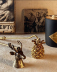 Saint O'Niell Alchemy's classic luxury scented candle vessel in black matte with gold metallic interior with two hand-forged candle snuffers in antique gold convey the elegant, natural aesthetic of the luxury brand.